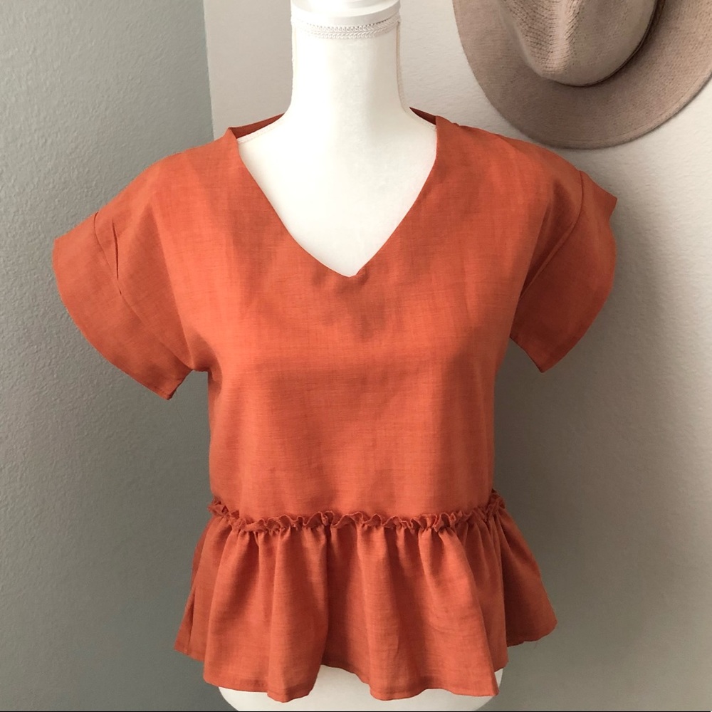 Burnt orange high/low peplum top